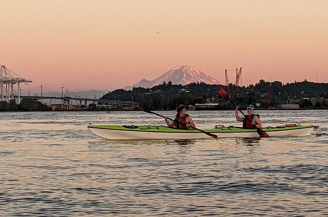 West Seattle Sunset Sea Kayak Tour - Elliott Bay waterfront at sunset: skyline, Olympic Mountains, and real-time timing